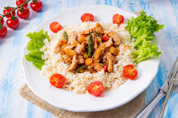 Turkey fricassee on rice with asparagus and paprika