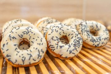 Donut with vanilla frosting and chocolate sprinkles topping