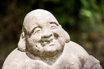 The close up image of Jizo (Burai / Hotei) by unknown sculptor on the street, Nagoya, Japan. In...