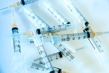 Syringes on blue background