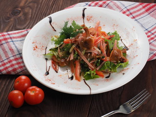 Marinated mushrooms and sausage in vegetable salad