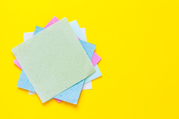 Colored notes paper. Post reminder papers.Sticky note paper reminder. Empty place for text. Set of different colored sticky note on a yellow background.