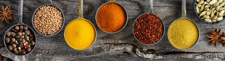 Wooden table of colorful spices. © alefat