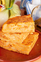 Close-up of portions of homemade (Spanish) potato omelette with natural ingredients (fresh eggs, olive oil, potatoes, onion, chorizo)