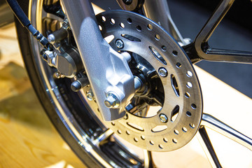 close up - wheel spokes and brake disc of a motorcycle concept new design technology