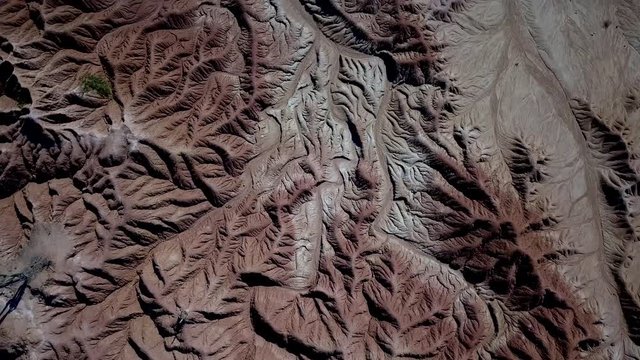 A spinning drone shot over the textures and patterns of the tatacoa desert in colombia