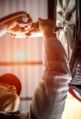 Professional mechanic , changing and adjusting car wheel in auto repair shop