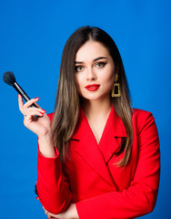 Sexy woman with professional makeup brush tool. jewelry earrings. Girl in red jacket. beauty and fashion. hair beauty and hairdresser salon. Fashion portrait of woman. Glamour fashion model