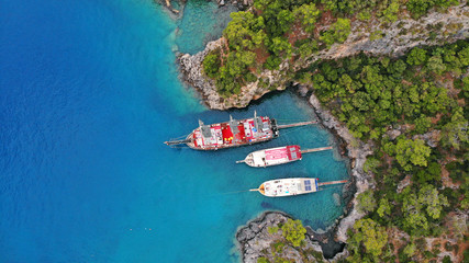 Touristic boats in the sea, top view. Aerial view of colorful boats standing abreast on the shore...