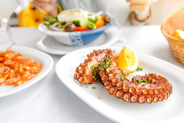 Top view of grilled shrimps and octopus on a table in seafood restaurant