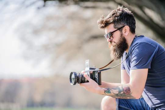 Smile. retro photographic equipment. brutal photographer with camera. photo of nature. reporter or journalist. hipster man in summer sunglasses. Mature hipster with beard. Bearded man. copy space - Powered by Adobe