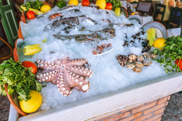 Assortment of fresh fish, raw octopus and other seafood at the fishermans market and restaurant...