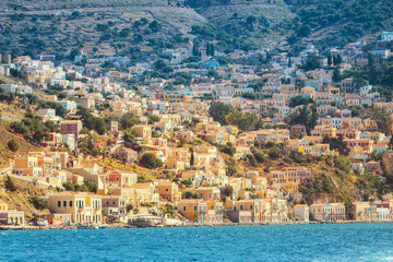 Fototapeta na wymiar Scenic vivid seascape of a Greek island of Symi in the Dodecanese, Greece . Popular tourist attraction
