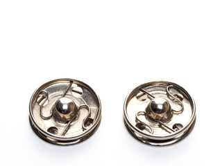 Two metal buttons on white background