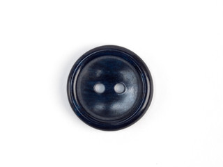 Dark blue plastic button on white background