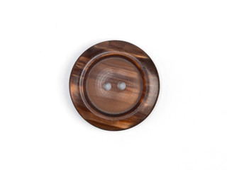 Brown plastic button on white background