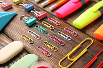 Flat lay composition with school supplies on wooden background