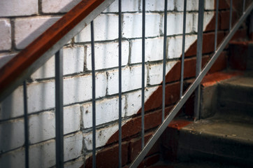 Metal Handrails, Concrete Stairs, White Brick Wall.