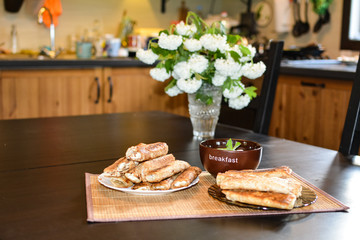 Pancakes in plates on the table with flowers