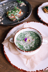 Okroshka. Summer light cold yogurt soup with cucumber, radish, eggs and dill on a wooden table. Close-up. Top view