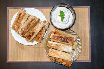 Pancakes in plates on the brown table