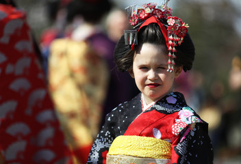 Little girl in traditional maiko outfit in Gion district, Kyoto, Japan