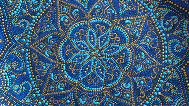Decorative ceramic plate with blue and golden colors, painted plates, close up, rotates, handmade. Decorative porcelain plate painted with acrylic paints, handwork
