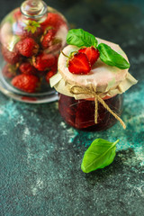 strawberry jam, ripe and juicy berries in a sweet dessert with basil. food background. top view. copy space