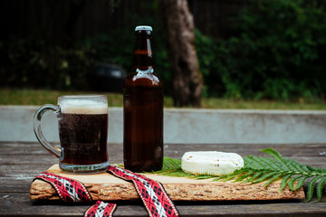 Latvian beer with latvian cheese and national folk belt