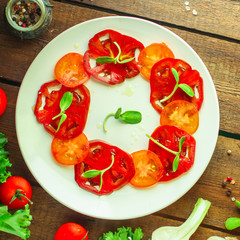 tomatoes salad with sunflower seedlings microgreen (carpaccio, sliced ​​raw vegetables). food background. top view. copy space
