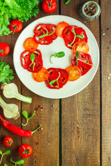 tomatoes salad with sunflower seedlings microgreen (carpaccio, sliced ​​raw vegetables). food background. top view. copy space