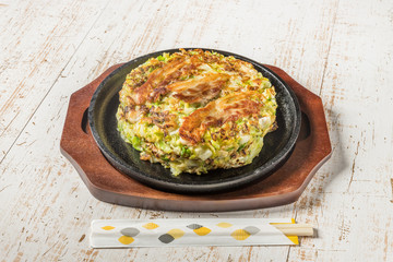 お好み焼き Okonomiyaki is a Japanese-style pancake