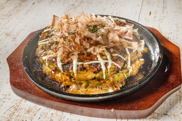 お好み焼き Okonomiyaki is a Japanese-style pancake