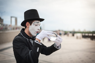 Mime on the street waiting to meet with his lover
