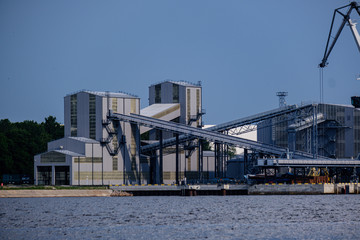 cargo shipping terminals in Riga, Latvia with high wind and dust flying over