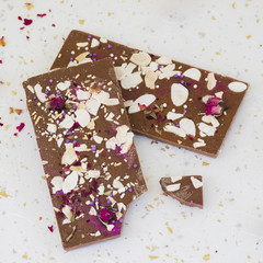 Sprinkles and rose petals on chocolate bar
