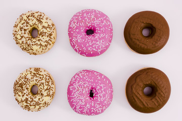Beige; pink and brown donut on white background