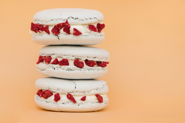 Stacked of white macaroon against colored background