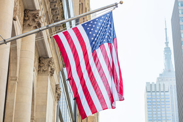 American flag, Manhattan downtown, blur Empire state building on the background