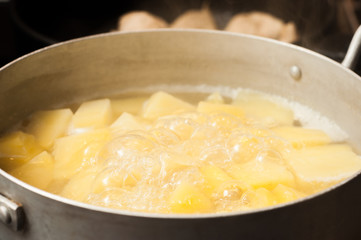 Bringing to readiness boiled potatoes diced. Aluminum pan.