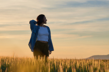  Young woman outdoors doing activities, with casual and modern style.