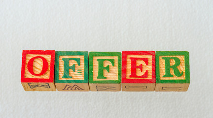 The term offer visually displayed on a clear background using colorful wooden blocks image in...