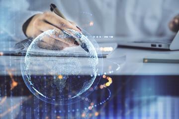 Multi exposure of hands making notes with world map hologram and data theme icons. Concept of global data.