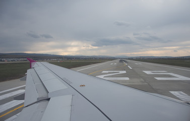 An airplane window view of wing and flaps 