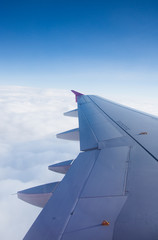 Fototapeta na wymiar An airplane window view of wing and flaps 