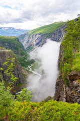 Falls in mountains of Norway. Waterfall Voringfossen - the fourth highest peak in Norway. Voringsfossen Waterfall. Hordaland, Summer Holiday in Norway Scandinavia.
