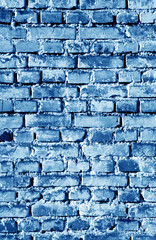 Old grungy brick wall surface in navy blue tone.