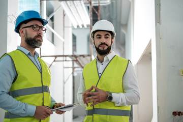 Engineers in hardhats having conversation