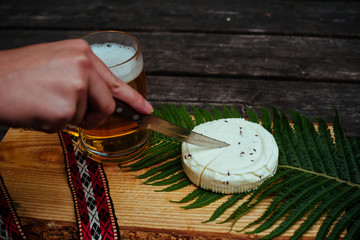 Latvian beer with latvian cheese and national folk belt