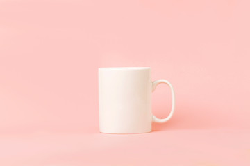 White coffee cup with copy space for the logo, text or design on pink background. Mock up, drink...